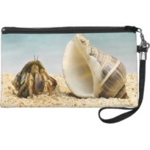 Hermit crab looking at larger shell Wristlet Clutches