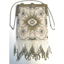 Elegant Antique Beaded Purse in Shimmery Silver and Glossy Gold Beads Against Pearly White Beaded Background