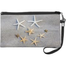 High angle view of a starfish on the beach Wristlet Clutches