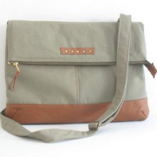 Olive khaki canvas foldover bag with leather, adjustable strap and brass zipper closure