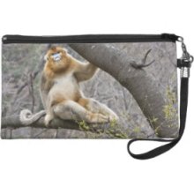 Portrait of male Golden monkey in tree Wristlet Clutch